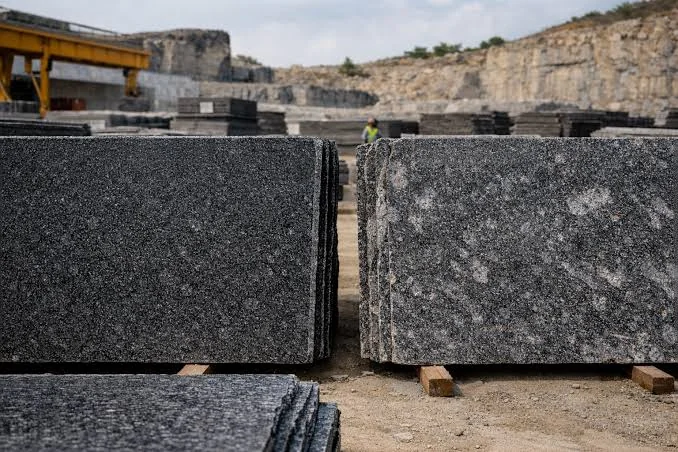 Polished black granite stone texture showcasing the premium quality materials used by TTK Divine Tombstones